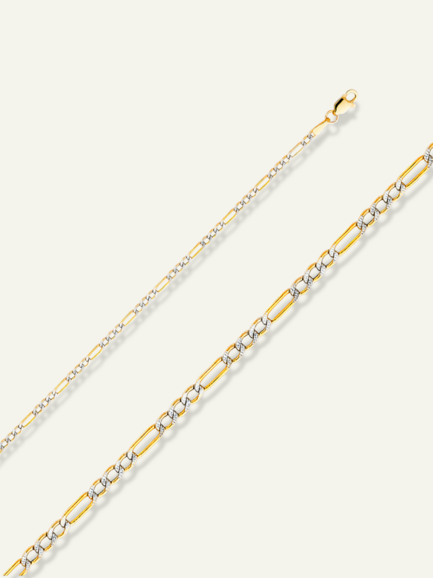 Two-toned 14K gold Figaro chain featuring yellow and white gold links, available in multiple lengths and widths, displayed on a neutral background.