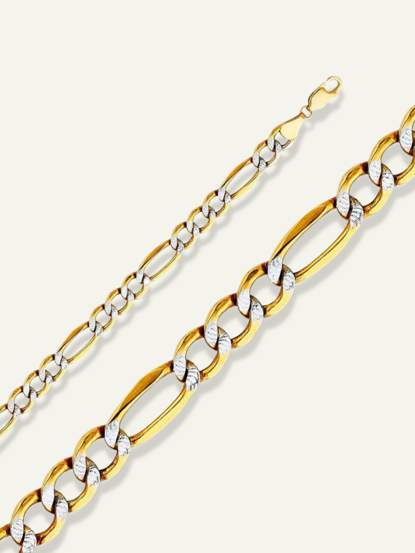 Two-toned 14K gold Figaro chain with yellow and white gold links, available in multiple sizes.