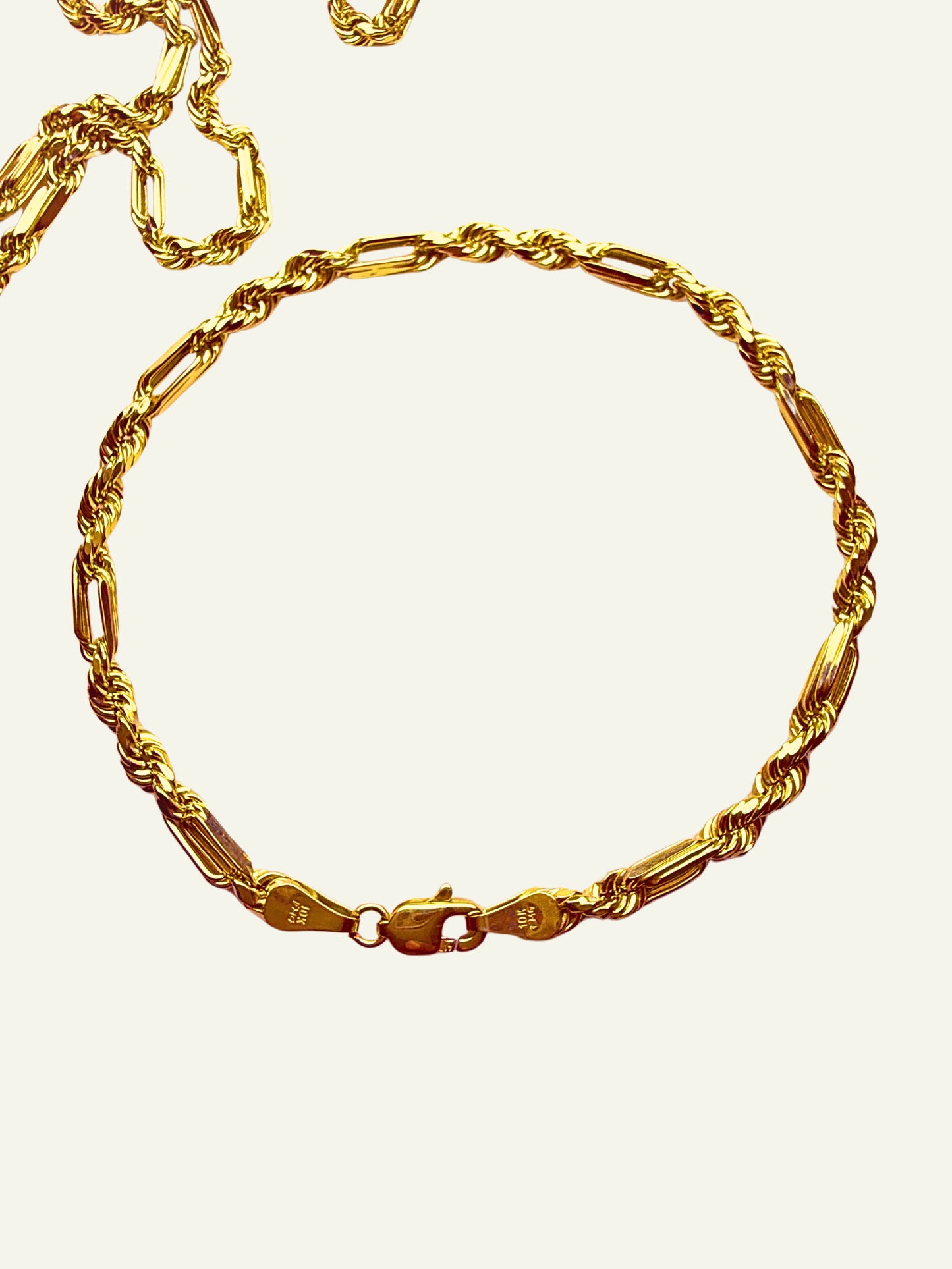Close-up of 10K Yellow Gold Figarope Milano Chain Bracelet with polished finish, Men’s 10K Gold Figarope Milano Bracelet featuring rope and Figaro link design, Stylish Figarope Milano bracelet in 10K yellow gold with lobster clasp, Elegant 10K gold chain bracelet combining rope and Figaro styles, Detailed view of 10K Yellow Gold Figarope Milano Bracelet on white background, 10K Gold Milano chain bracelet for men with textured links, goldnboys. 