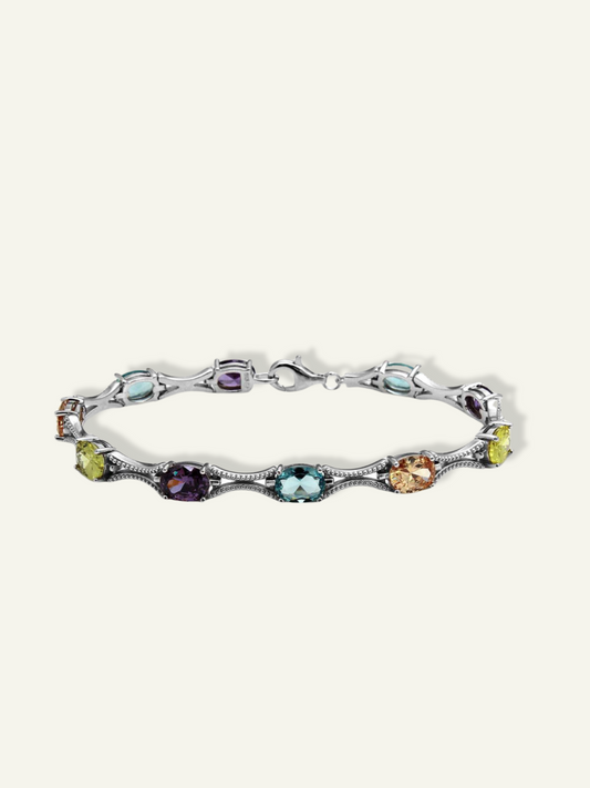 925 silver tennis bracelet featuring 10 colorful oval cubic zirconia gems.